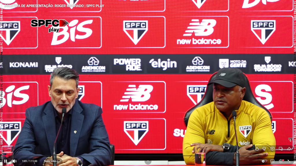 Apresentação de Roger Machado como novo técnico do São Paulo FC em coletiva de imprensa, com painel de patrocinadores ao fundo.